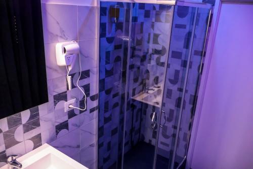 a bathroom with a shower and a toilet and a sink at Wellness Home Catania in Catania
