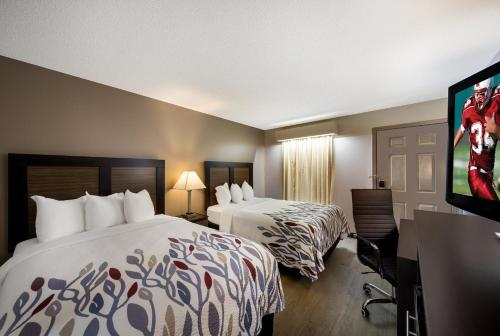 ジャスパーにあるRed Roof Inn Jasperのベッド2台、薄型テレビが備わるホテルルームです。