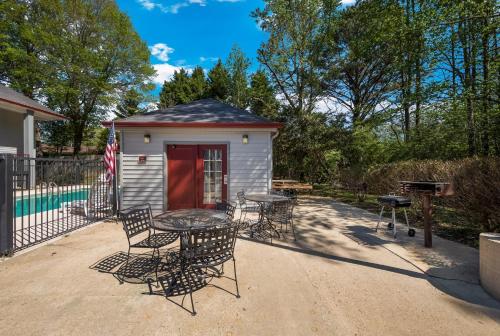 a patio with a table and chairs and a grill at Red Roof Inn Jasper in Jasper