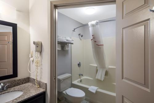 a bathroom with a toilet and a sink and a phone at Red Roof Inn Jasper in Jasper