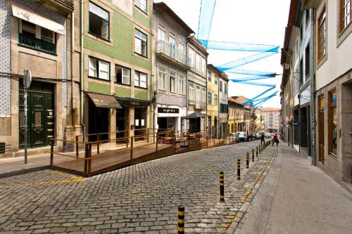 a cobblestone street in a city with buildings at Oporto Blue Liberdade - Citycenter View Penthouse Studio in Porto