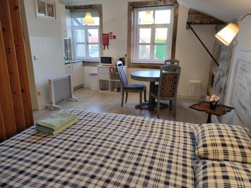 a bedroom with a bed and a table and chairs at Oporto Blue Liberdade - Citycenter View Penthouse Studio in Porto