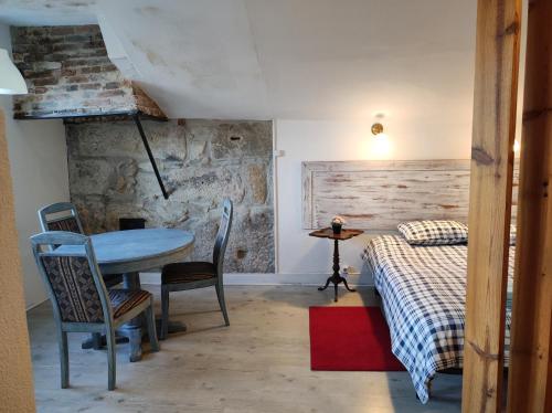 a room with a table and a bed and a table and chairs at Oporto Blue Liberdade - Citycenter View Penthouse Studio in Porto