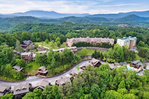 an aerial view of a resort with a road and trees at 2 Miles from Dollywood Family Resort with Seasonal Outdoor Swimming Pool, Year around Heated Indoor Swimming Pool, Townhome Style Cabin, Private Hot Tub, Arcade, TV, Wifi, Kitchen with Refrigerator, Washer and Dryer in Pigeon Forge