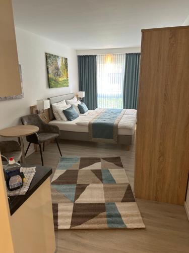 a bedroom with a bed and a living room at Hotel Apartments 73 - Serviced Apartments in Neu Wulmstorf