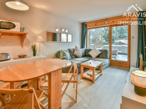 a living room with a table and a couch at Appartement Le Grand-Bornand, 2 pièces, 4 personnes - FR-1-391-95 in Le Grand-Bornand