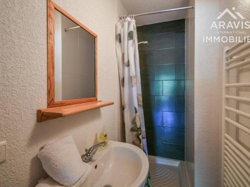 a bathroom with a sink and a shower with a mirror at Appartement Le Grand-Bornand, 4 pièces, 6 personnes - FR-1-391-98 in Le Grand-Bornand