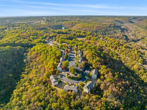 an aerial view of a building in the middle of a forest at StoneBridge Village Resort in Reeds Spring
