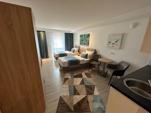a living room with a bed and a couch at Hotel Apartments 73 - Serviced Apartments in Neu Wulmstorf