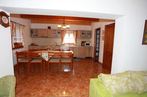 a kitchen and dining room with a table and chairs at Drevenice Osádka in Osádka