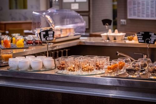a buffet line with glasses of food and drinks at Hotel Litteraire Le Swann, BW Premier Collection in Paris