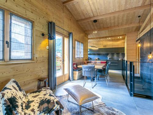 une cuisine et un salon avec une table et des chaises dans l'établissement Chalet 4**** La Clusaz: sur les pistes, 10 pers, terrasse, garage, Wifi, linge inclus - FR-1-437-80, à La Clusaz