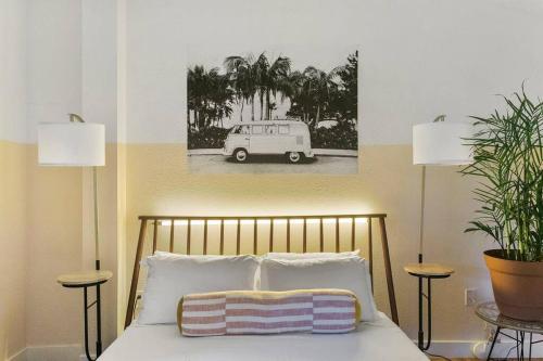 a bedroom with a bed with a picture of a car at Studio Unit.hōʻoluʻolu in Chandler