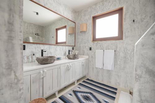 a bathroom with two sinks and a mirror at Kai Tulum in Tulum
