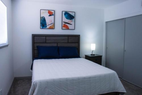 a bedroom with a bed and three paintings on the wall at House in Las Vegas in Las Vegas