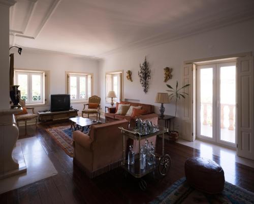 a living room with a couch and a table at Casa Da Palmeira in Leiria