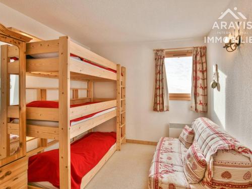 a bedroom with two bunk beds and a window at Appartement Le Grand-Bornand, 3 pièces, 5 personnes - FR-1-391-132 in Le Grand-Bornand