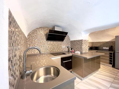 a kitchen with a stainless steel sink in a room at The Beverley Apartments London - Victoria in London