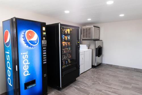 a soda machine in a room with a refrigerator at Econo Inn in Worland