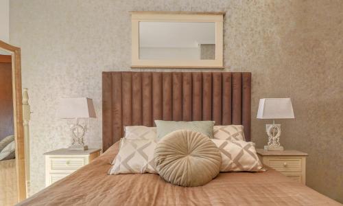 a bedroom with a large bed with two night stands at Vida Mia Almeria - Superior Apartment in Vera