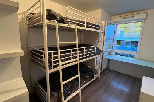 a walk in closet with white shelves and a window at Appartement standing proche Arena Paris La Défense in Nanterre