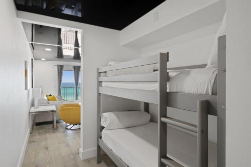 a bedroom with bunk beds and a desk at The Summit 702 in Panama City Beach