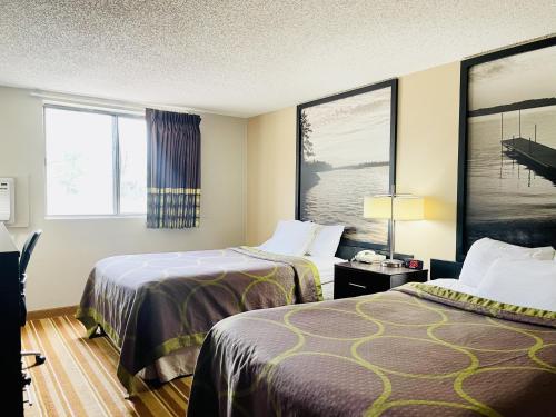 a hotel room with two beds and a window at Super 8 by Wyndham Clear Lake in Clear Lake