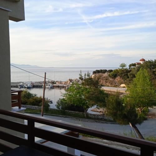 a view of the water from the balcony of a house at Porto Athos apartments in Nea Roda