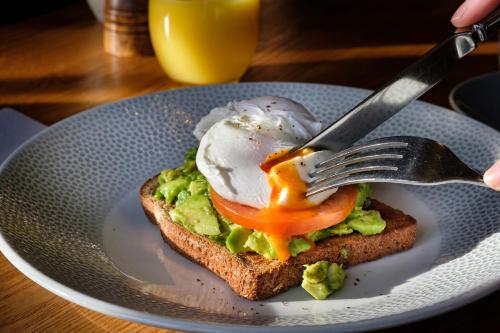 a egg on top of a piece of toast with a fork at The Weeping Willow in Bury Saint Edmunds