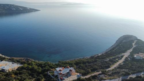 an aerial view of a large body of water at Blue and White in Schinias