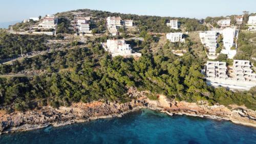 an aerial view of a resort on a beach at Blue and White in Schinias