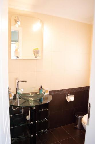 a bathroom with a sink and a mirror at Blue and White in Schinias