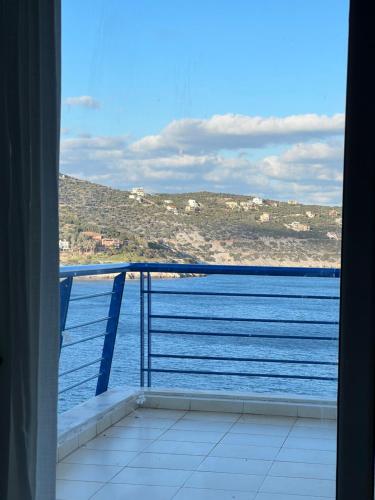 a view of the ocean from a balcony at Blue and White in Schinias