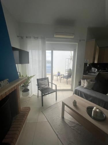 a living room with a couch and a table and a living room with a view at Blue and White in Schinias