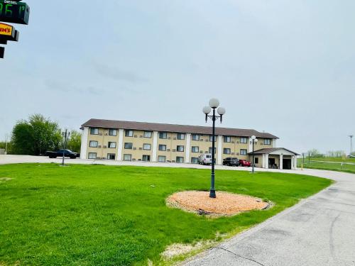 a building with a light pole in the grass at Super 8 by Wyndham Clear Lake in Clear Lake