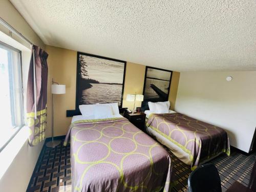a hotel room with two beds and a window at Super 8 by Wyndham Clear Lake in Clear Lake