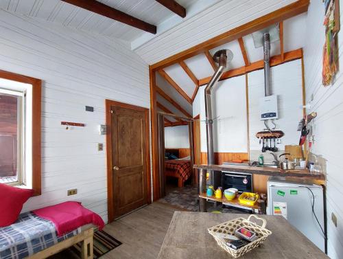 a kitchen with a sink and a table in a room at Cabañas Pukem in Malalcahuello
