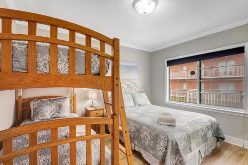 a bedroom with a bunk bed next to a window at Sunset Bay I 306 in Ocean City