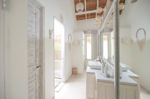 a bathroom with two sinks and a mirror at Kai Tulum in Tulum