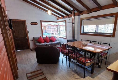 a living room with a table and a couch at Cabañas Pukem in Malalcahuello