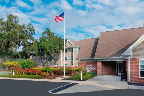 an american flag on a pole in front of a building at Residence Inn by Marriott Sarasota Bradenton in Sarasota