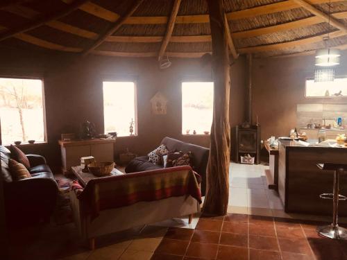 a living room with a couch and some windows at Refugio Andino con vista al volcán. in San Pedro de Atacama