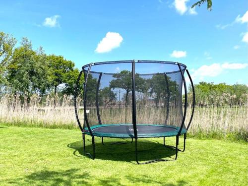 a metal trampoline in the middle of a field at Landgoed Meersen in Maldegem