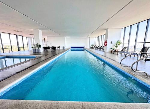 a swimming pool with blue water in a building at Departamento Grand 4H-154 in Guadalajara