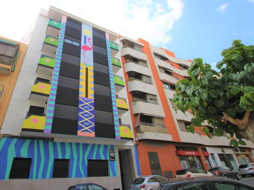 a building with a painting on the side of it at CASATURIS NEWON APARTAMENTOS en EL CAMPELLO in El Campello