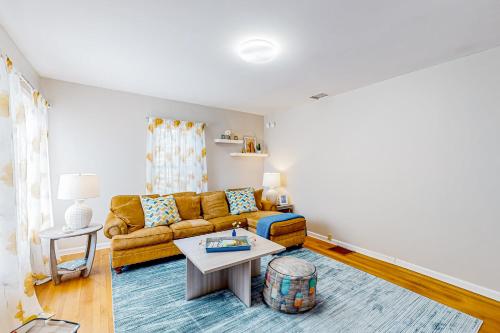 a living room with a couch and a table at Maplewood Manor - Unit 1 in Colchester