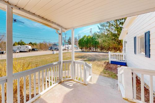 a front porch of a white house with awning at Maplewood Manor - Unit 1 in Colchester