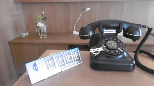 a black phone sitting on top of a table at Hotel Riviera in Arenzano