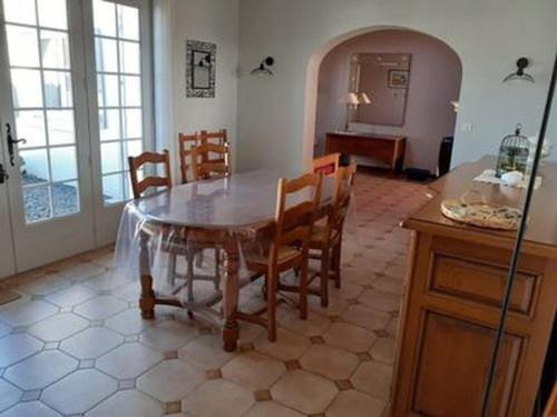 - une cuisine avec une table à manger et des chaises dans l'établissement Belle maison à Saint-Hilaire-de-Riez, 2 chambres, proche plage, sur terrain clos - FR-1-324-505, à Saint-Hilaire-de-Riez