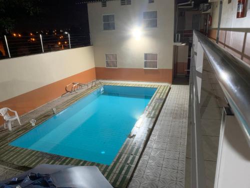 a large swimming pool in a building at Hotel Itatiaia in São Luís